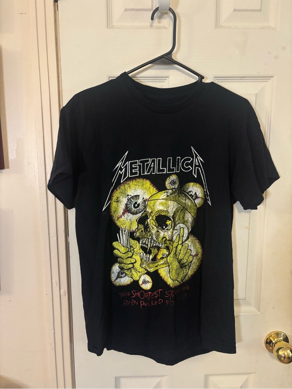 Black Graphic Tee with Yellow Skull Artwork metallica